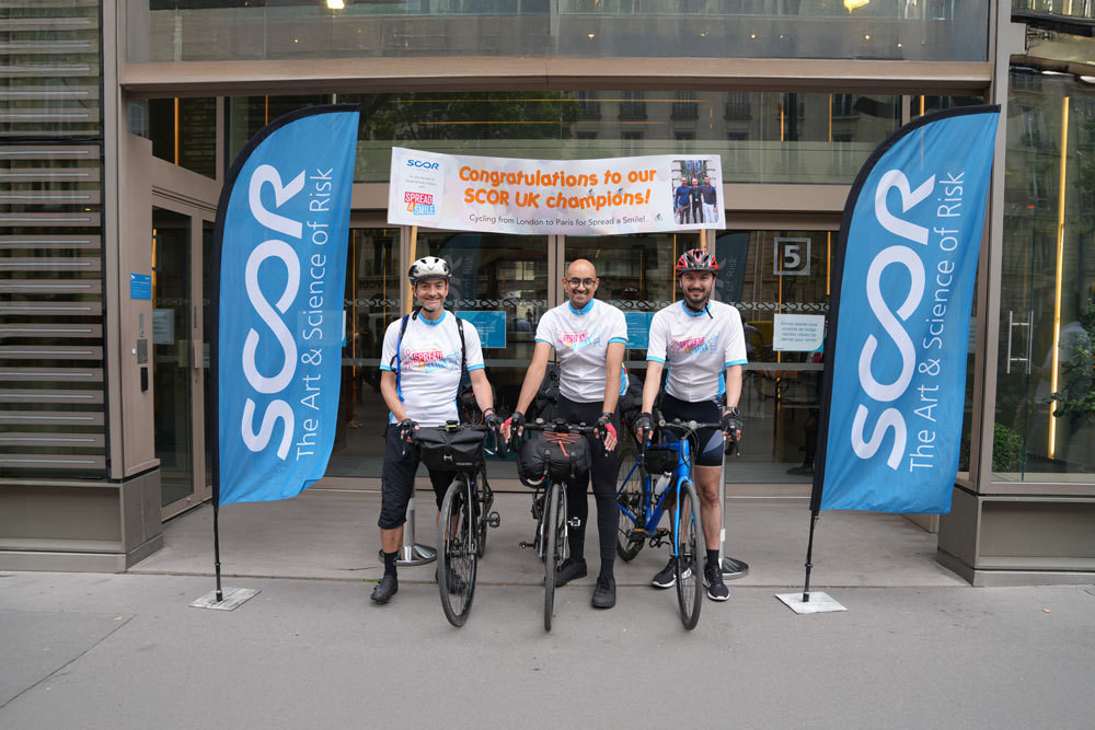 May 2025 Life at SCOR Careers Blog post photo with the SCOR Champions on their bike
