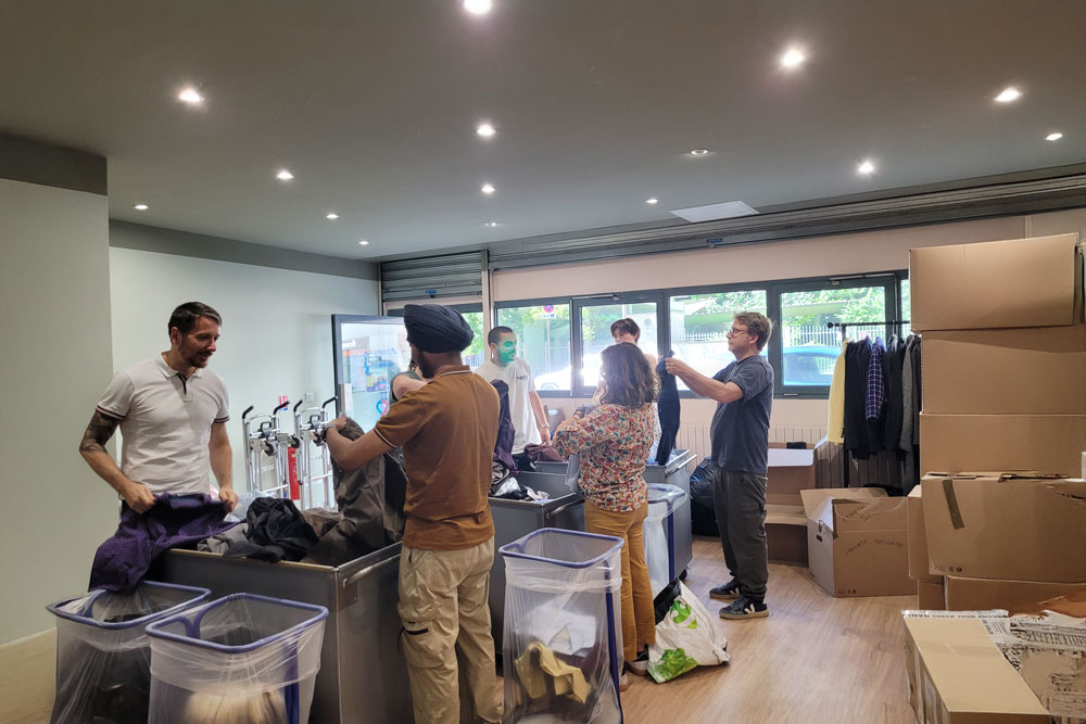 May 2025 Life at SCOR Careers Blog post photo with people handling clothing donations