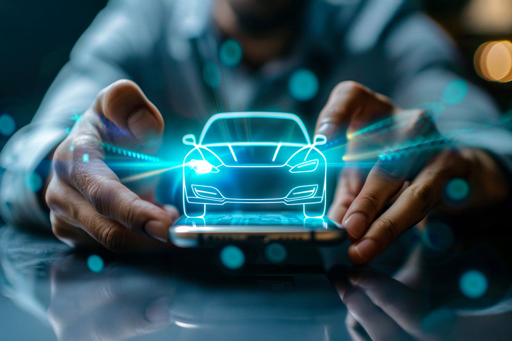 Man holding a small car with bright lights on, connected car