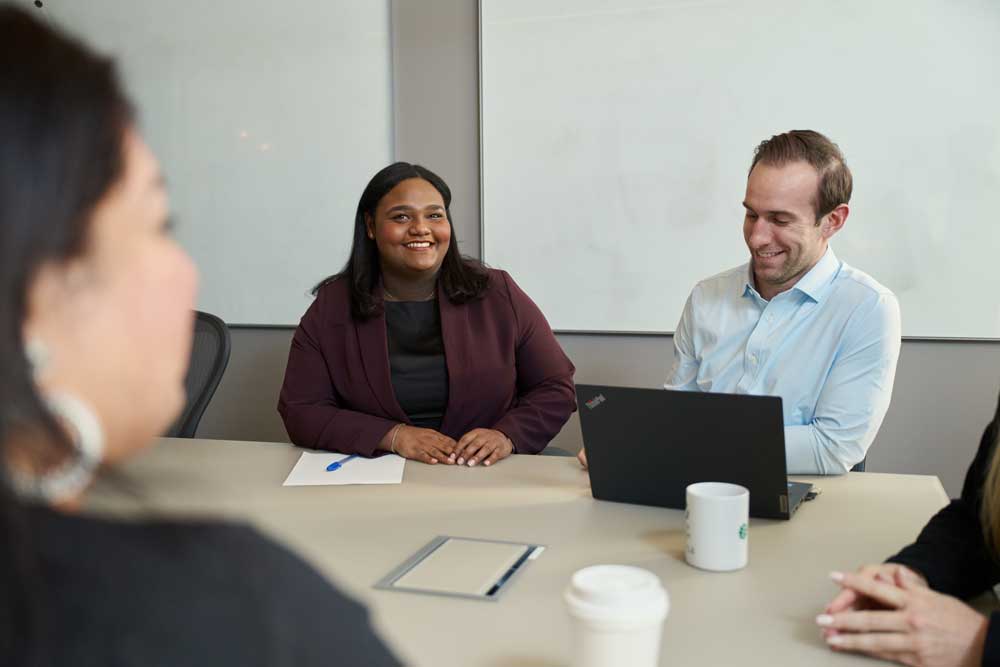 SCOR employees meeting in an office in New York