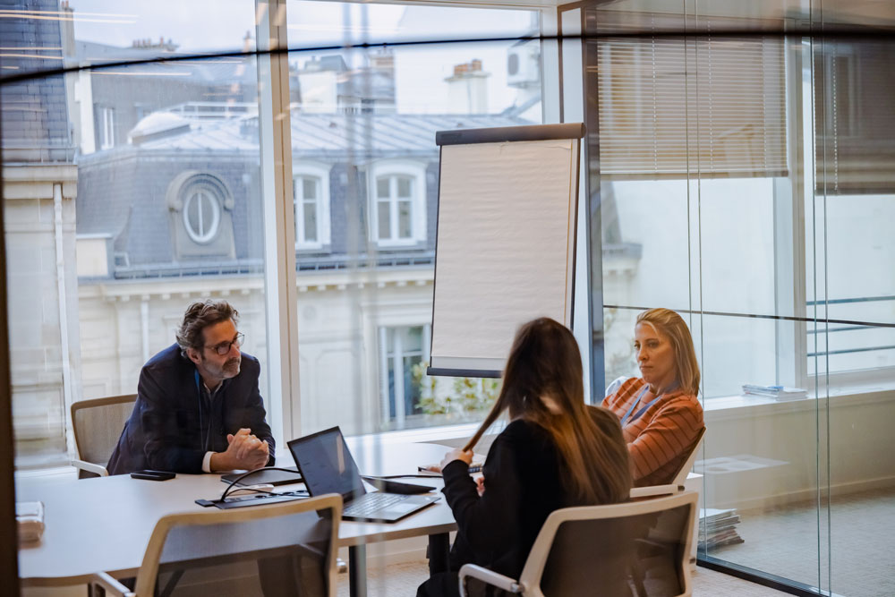 SCOR team in a work meeting at the Paris offices, discussing analysis, finance and data issues in a collaborative environment