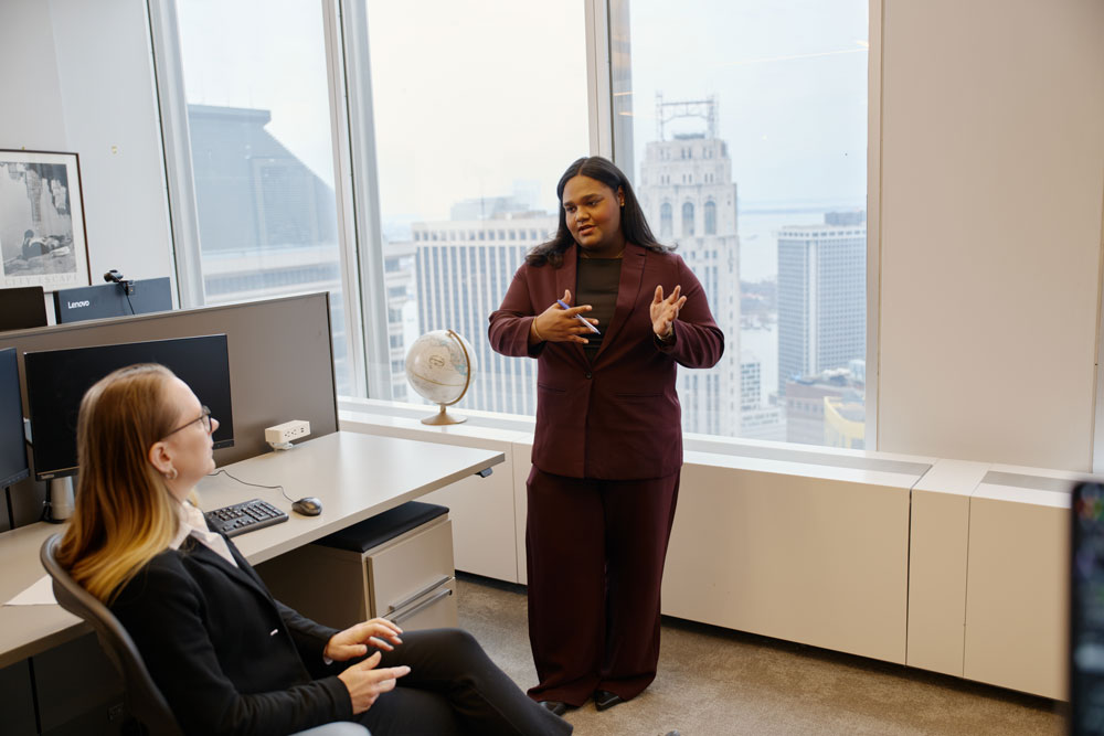 SCOR employee presenting career opportunities to a colleague in the New York office, illustrating professional development within the reinsurance leader