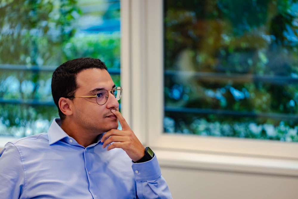 SCOR employee paying close attention during a meeting, focused on a data presentation illustrating analytical excellence and a culture of innovation