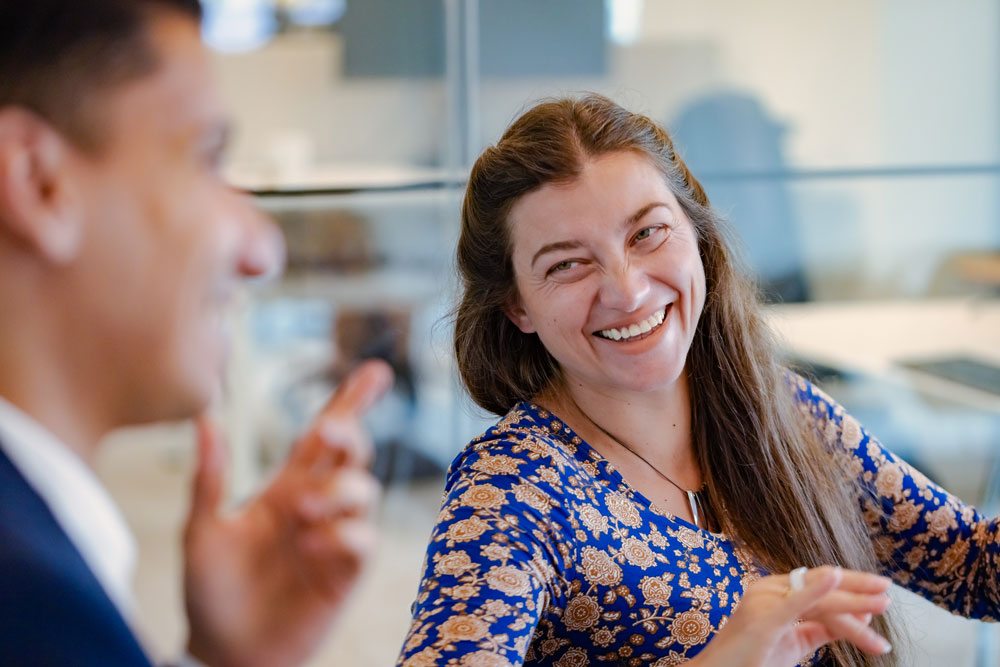 SCOR employees engaged in professional discussions in the offices, embodying expertise, collaboration and innovation as an employer brand