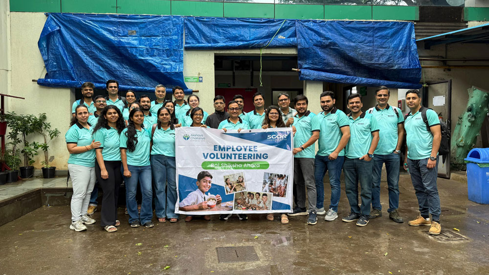 SCOR Voices June 2026 article about SCOR for Good image with Nazneen serving free meals in a school in Mumbai