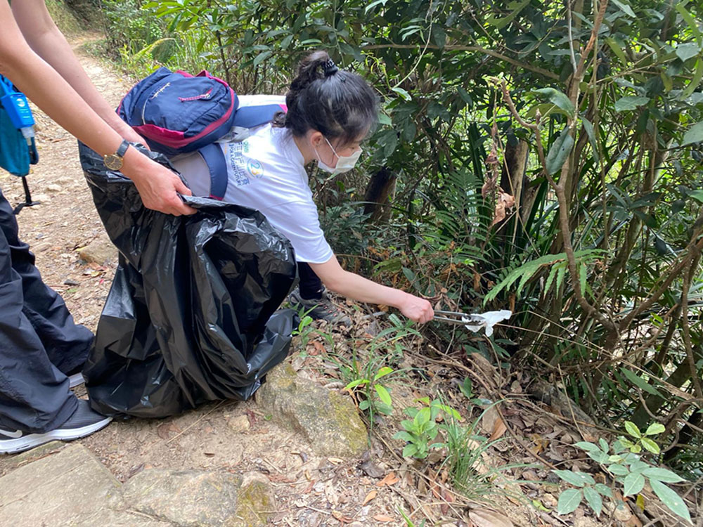SCOR Voices June 2026 article about SCOR for Good image with Ye cleaning a trail