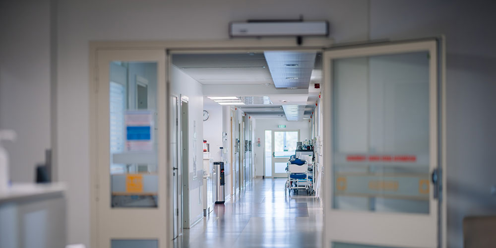 Hospital Floor Interior, empty hospital corridor with reflective floor, doors, and waiting chairs