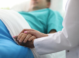 doctor holding patient hand