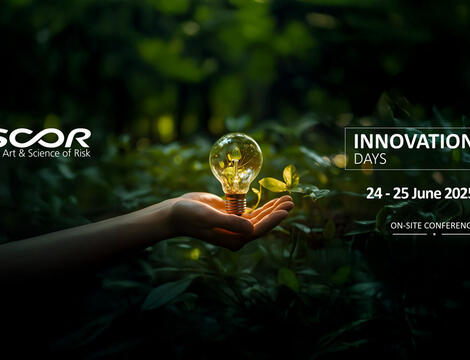 Hand surrounded by leaves holding a light bulb filled