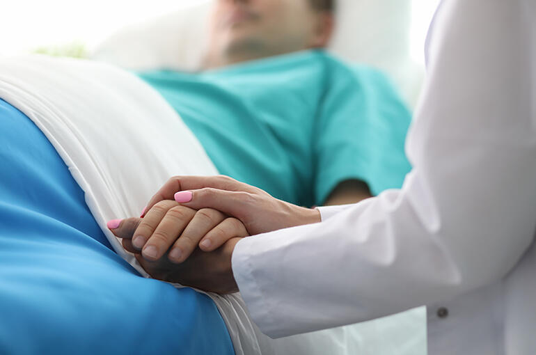 doctor holding patient hand