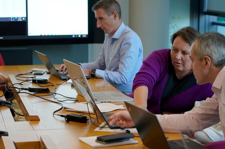 Three people at a hackathon