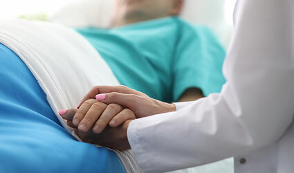 doctor holding patient hand