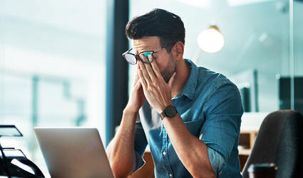 Burnout, fatigue and worker at computer with pain, brain fog and frustrated with mistake