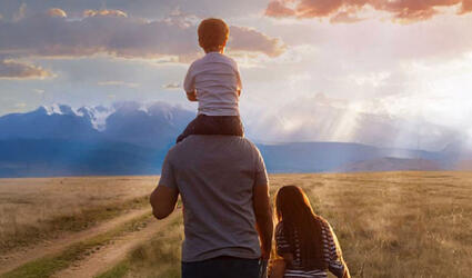 Man with children in a land field