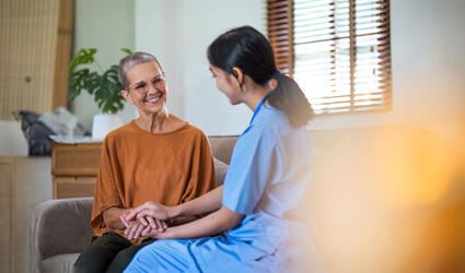 Page header picture of SCOR L&H Expert View titled Insurance Inclusivity and the Right to Be Forgotten with a carer and her patient