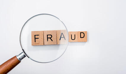 Fraud with magnifying glass