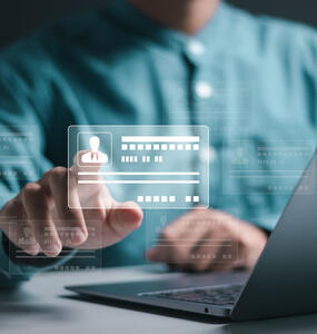 Businessman use laptop and hand touch virtual screen of digital identification card to accessing databases by digital identity for cyber security