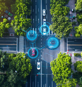 SCOR P&C mobility page header image with aerial view of autonomous cars navigating a city intersection, highlighted by digital overlays illustrating advanced driving technology and connectivity